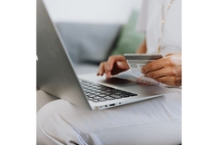 Ordering online with credit card and laptop.